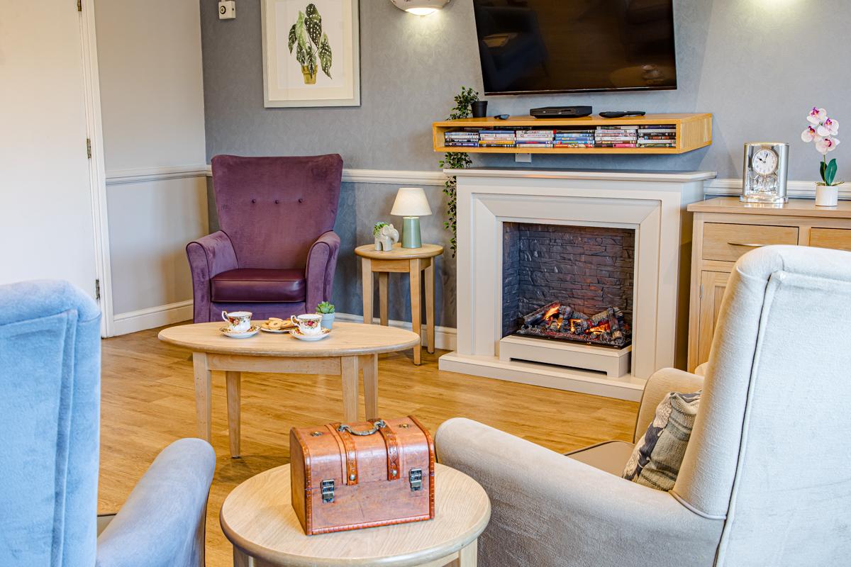 lounge area with chairs and a fire place