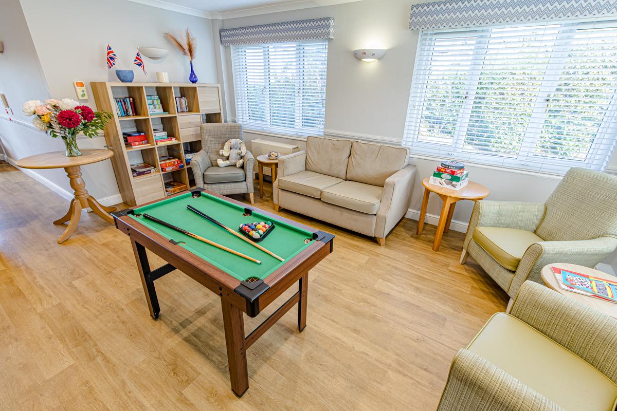 pool table in a games room with books and games